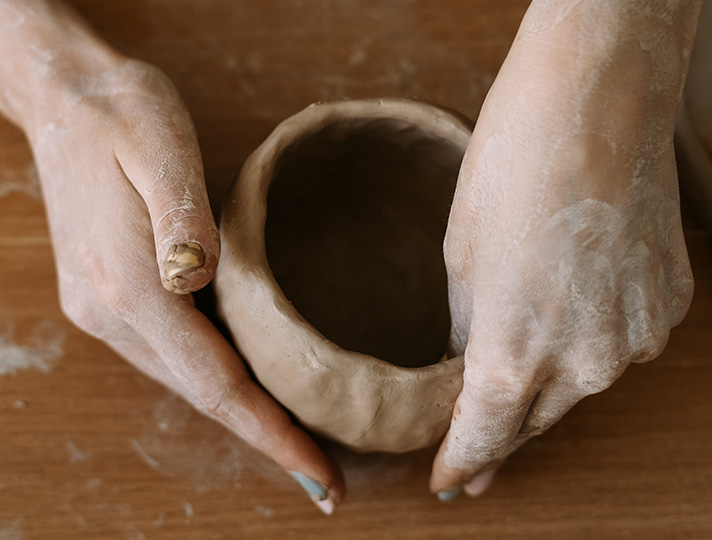 Student creating pot